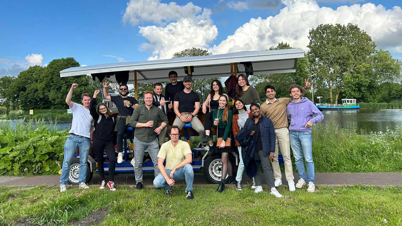 A big student group riding the PedalCity party bike through the city